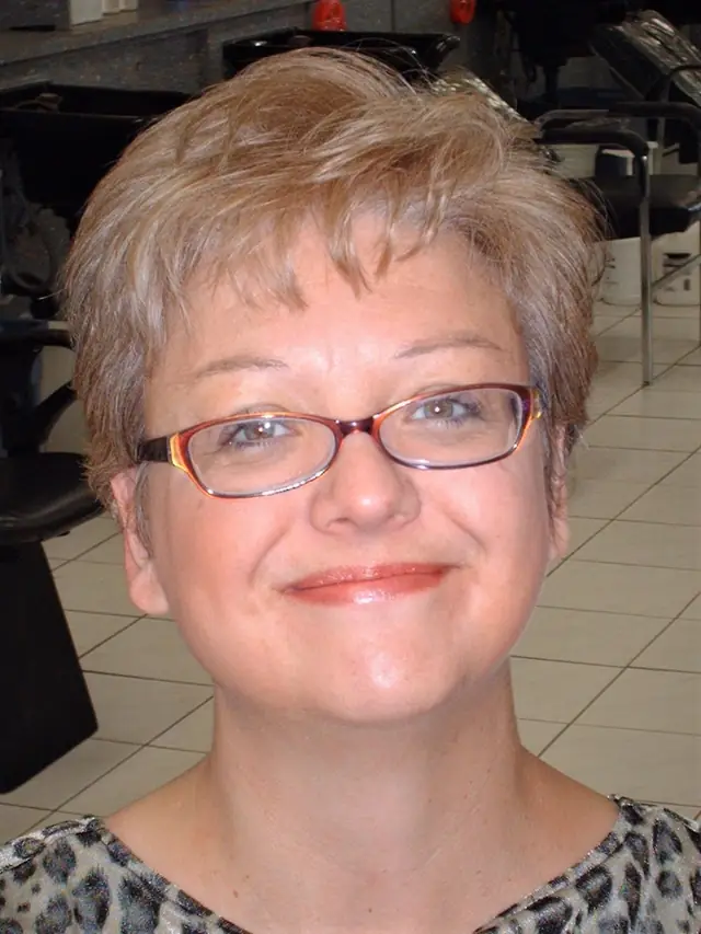 Barb in a relaxed, casual portrait against a warm background